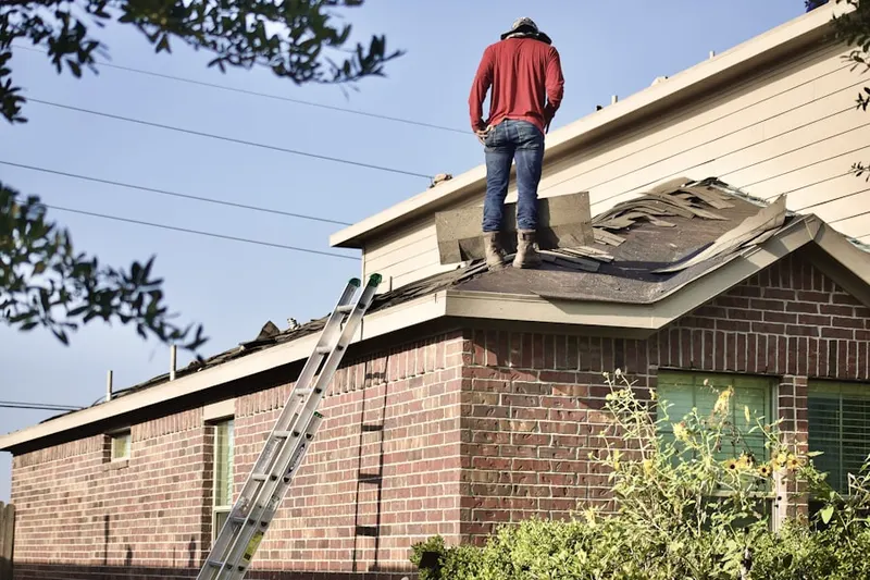 Professional roofer working on a residential roof in Boulder Park